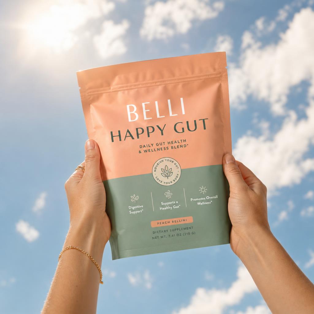 Hands holding the Belli Happy Gut pouch against a blue sky